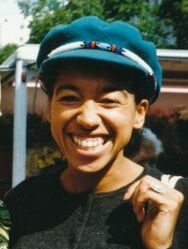 image of May Ayim smiling with a blue hat