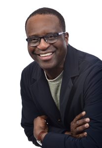 A man wearing glasses and a black jacket.